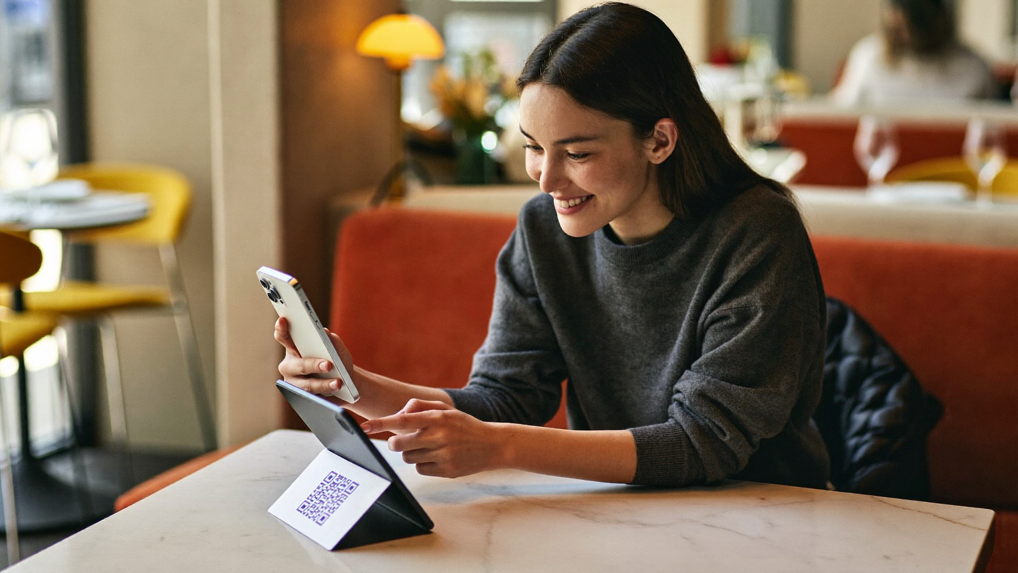 Cliente escaneando un código QR sobre la mesa para dejar una reseña en Google